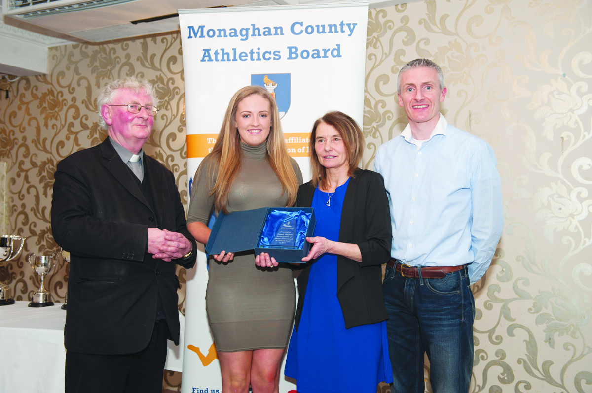 Leah Barry, 2nd from left, accepting the presentation on behalf of Niamh Malone, Monaghan Phoenix AC, from Rose Lambe. Also included are Fr Paudge Corrigan and Chairman of the Monaghan County Athletics Board, Alan Clarke. Â©Rory Geary/The Northern Standard