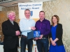 Chairman of the Monaghan County Athletics Board, Alan Clarke, 2nd from left, making the presentation to Damien Barry, Monaghan Phoenix AC. Also included are Fr Paudge Corrigan and Rose Lambe. Â©Rory Geary/The Northern Standard