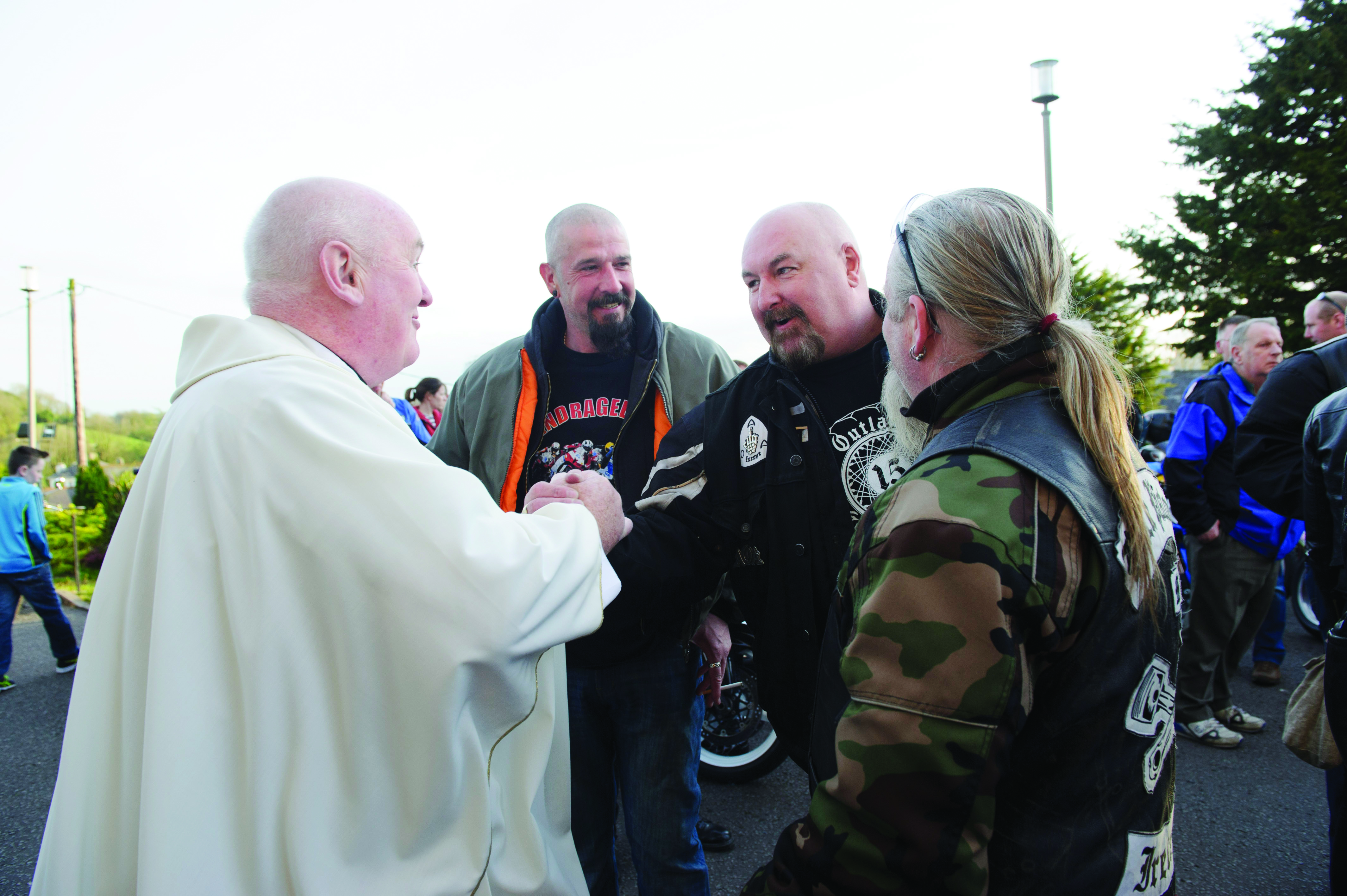 Fr John  Kierans is welcomed by some of the motorbike club members at the Gone But Not Forgotten Bikers Mass. Â©Rory Geary/The Northern Standard
