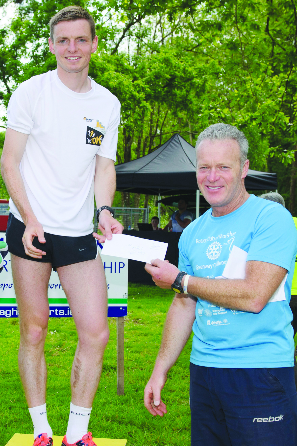 Peter McKenna, right, making the presentation of the prize to winner of the Blackwater 10k, Conor Duffy, Glaslough Harriers. Â©Rory Geary/The Northern Standard