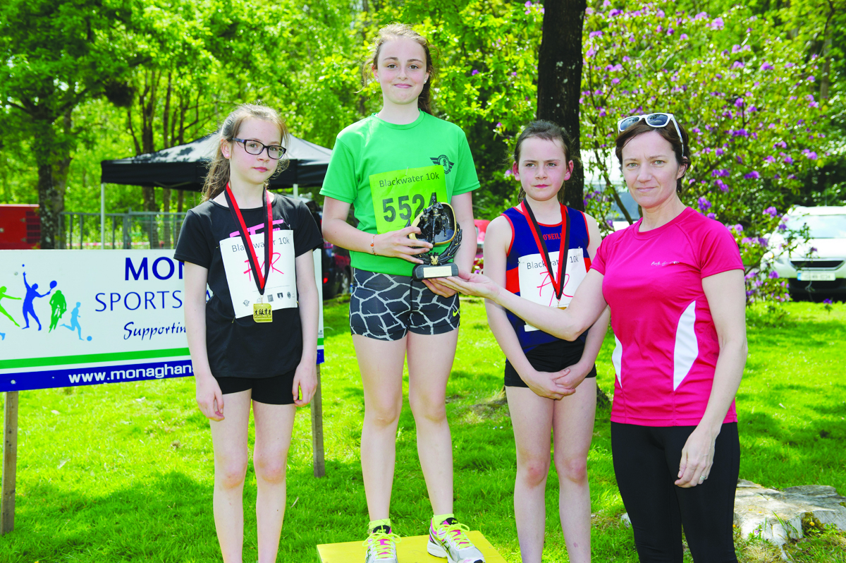 Michelle Murphy, right, Monaghan Sports Partnership, making the presentation of the prizes for the Girls 3k Funrun to (L-R) Yasmin O'Leary, Monaghan Phoenix AC, 2nd, CÃ­ona Barry, centre, representing Emma Glynn, Monaghan Phoenix AC, winner and Amy Jo Kearns, Oriel AC, 3rd. Â©Rory Geary/The Northern Standard