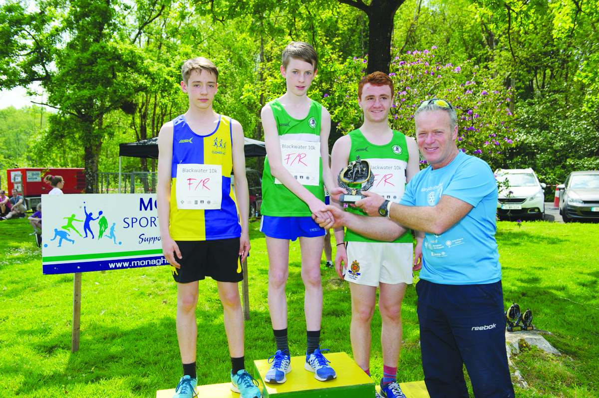 Peter McKenna, right, making the presentation of the prizes for the 3k funrun to winner, Andrew McKenna, centre, Monaghan Phoenix AC, Jamie McMahon, left, Clones AC, 2nd and Oisin Fagan, right, Monaghan Phoenix AC, 3rd. Â©Rory Geary/The Northern Standard