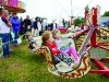 Some of the children on one of the fairground rides at the Carrickroe Welcome Home Festival. Â©Rory Geary/The Northern Standard