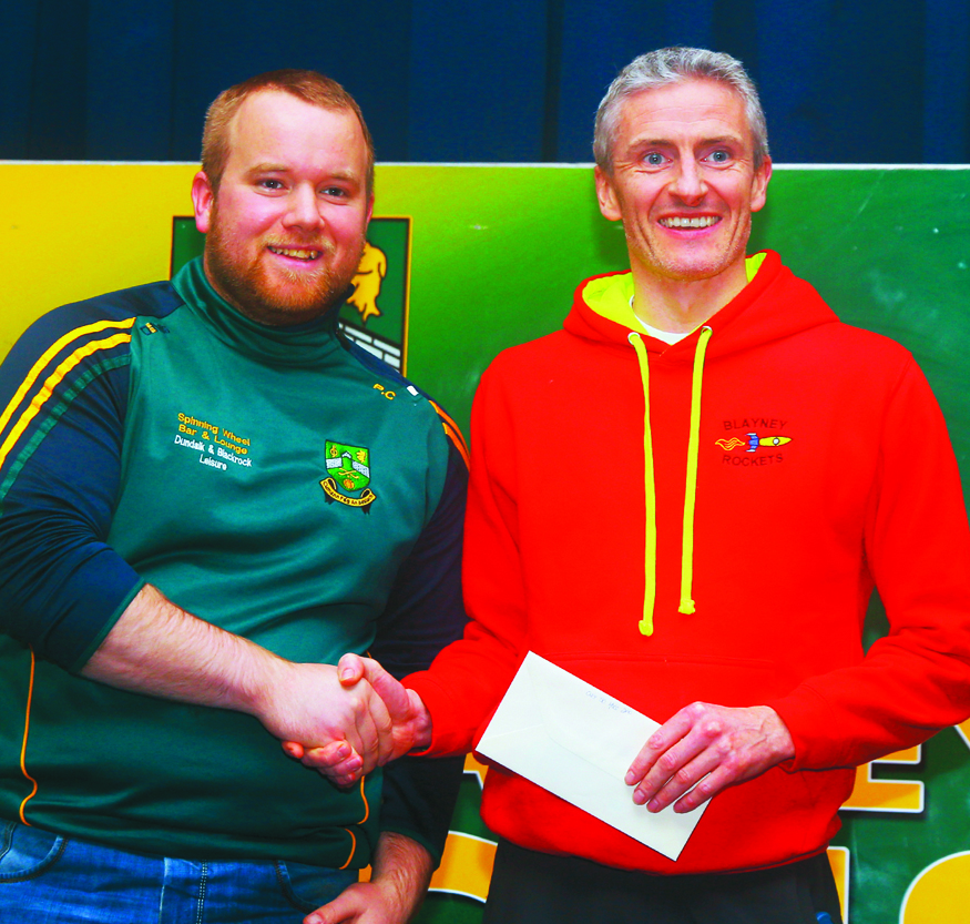 Alan Clarke, gets an award from Paddy Conlon, after the Super Valu 5k Walk/Run in Castleblayney on Sunday last. Picture: Jimmy Walsh