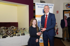 Meave Smith, Carrick Aces, being presented with her award by Alan Clarke, chairman of the Monaghan County Athletics Board. Â©Rory Geary/The Northern Standard