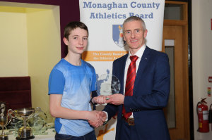 Liam McKenna, Glaslough Harriers, accepting his award by Alan Clarke, chairman of the Monaghan County Athletics Board. Â©Rory Geary/The Northern Standard