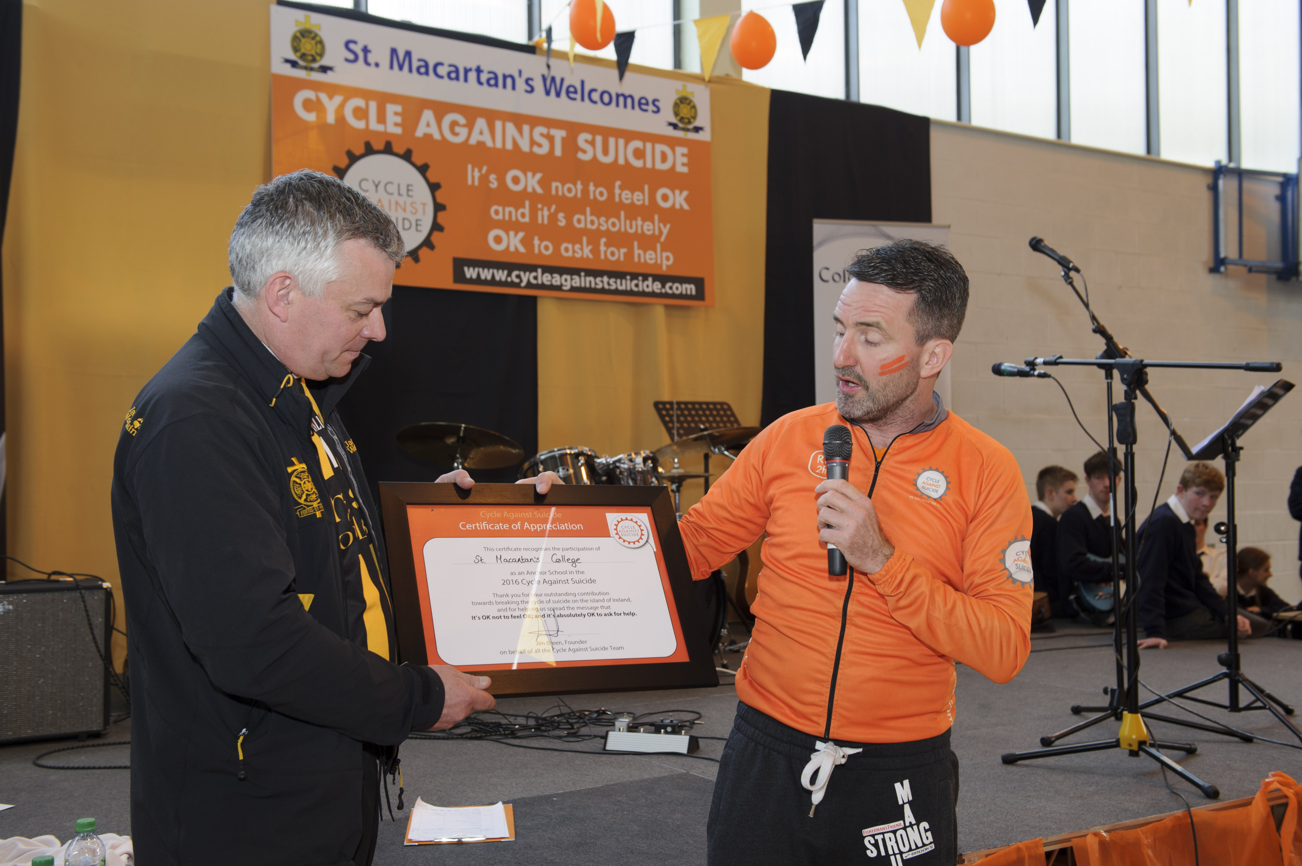 Jim Breen, right, founder of the Cycle Against Suicide, making a presentation to Raymond McHugh, Principal of St Macartan's College, in appreciation of the school hosting the event. Â©Rory Geary/The Northern Standard