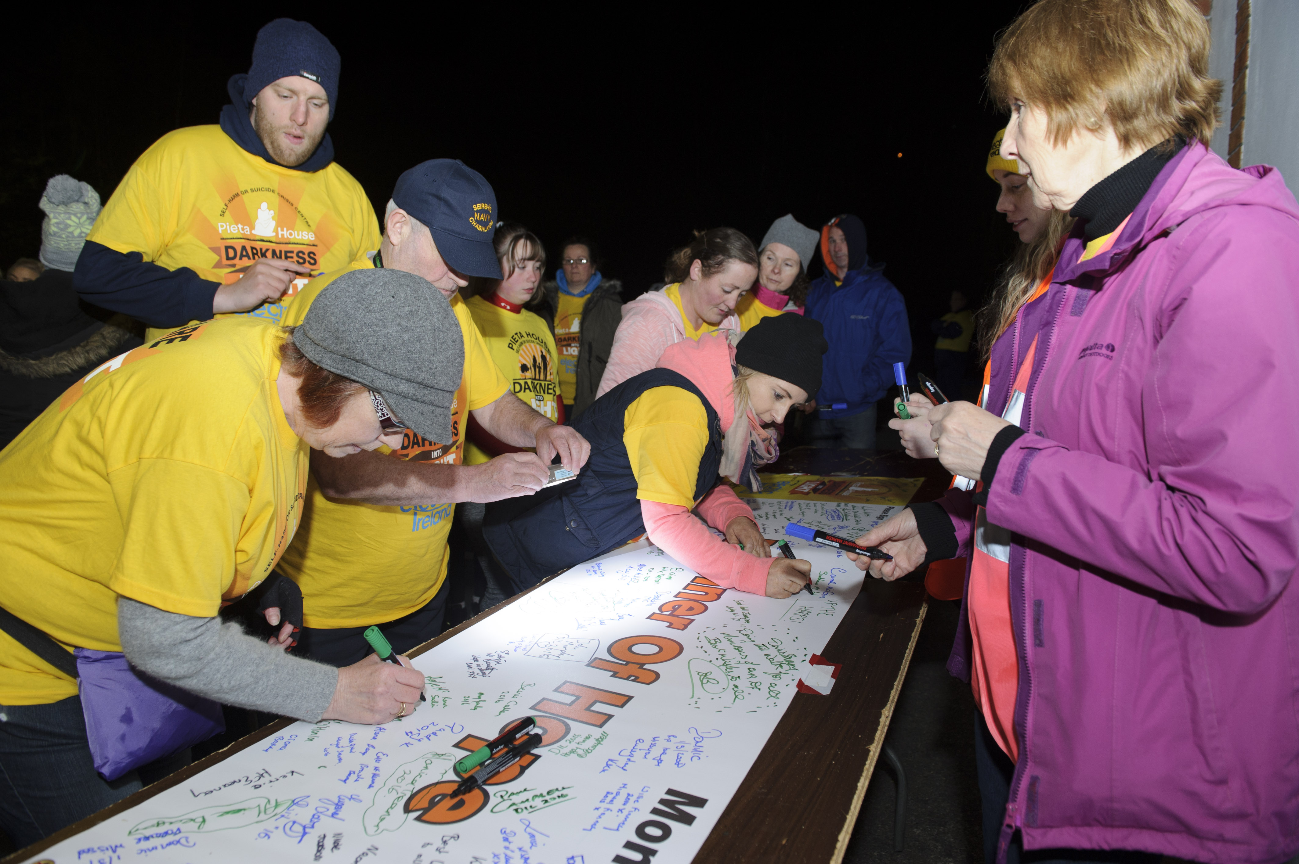 Some of the runners at the Monaghan Darkness Into Light signing a banner at the event. Â©Rory Geary/The Northern Standard