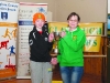 Liam McKenna, is presented by the McKenna Cup for the Boys U-14 1000m race by Bernie Murphy, Glaslough Harriers. Â©Rory Geary/The Northern Standard