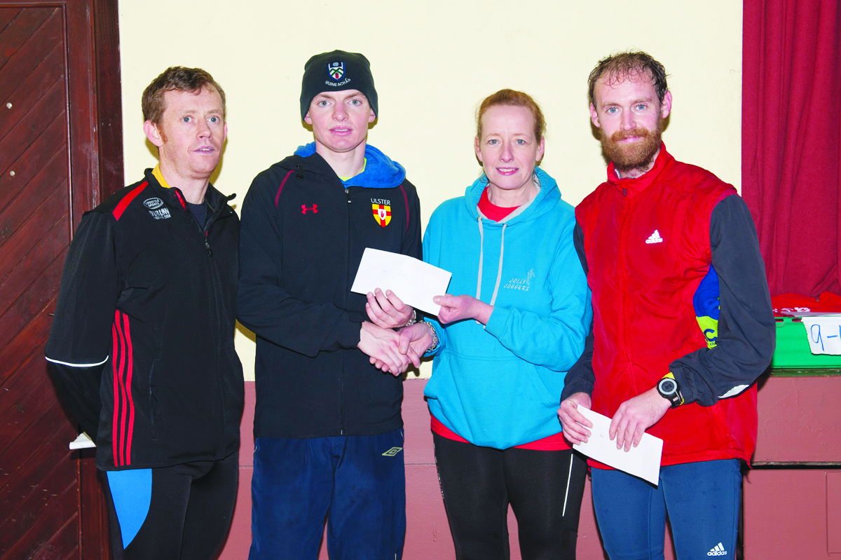 Kate McAree, Glaslough Harriers Jolly Joggers, making the presentation to Conor Duffy, Glaslough Harriers, winner of the Glaslough Harriers Jolly Joggers 10k. Also included are Patrick Cassidy, left, Glaslough Harriers, 3rd and Simon Ryan, 2nd, Raheny Shamrocks. Â©Rory Geary/The Northern Standard