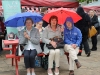 Taking shelter from the rain during the Monaghan Canada Day celebrations were (L-R) Peggy McElwaine, Violet and Mark McCabe. Â©Rory Geary/The Northern Standard
