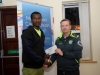 Winner of the Monaghan Credit Union Monaghan Phoenix AC 5k, Eskander Turki, Monaghan Town Runners, being presented by Damien Barry, right, Monaghan Phoenix AC. Â©Rory Geary/The Northern Standard