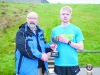 Winner of the Monaghan Phoenix AC Goal Mile, Paul Peppard, right, being presented with the Fiona Kieran Memorial Cup by Macartan Kieran. Â©Rory Geary/The Northern Standard