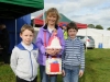 Josephine Duffy, centre, with her entry for one of the classes at Tydavnet Show with nephews, John and James Mullen. Â©Rory Geary/The Northern Standard