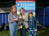 Tydavnet Show Queen Shauna McAree, left and President of Tydavnet Show, Mary Sherry, right, presenting Heather Stirratt, with The Courthouse Bar Cup for Almond Slices. Â©Rory Geary/The Northern Standard